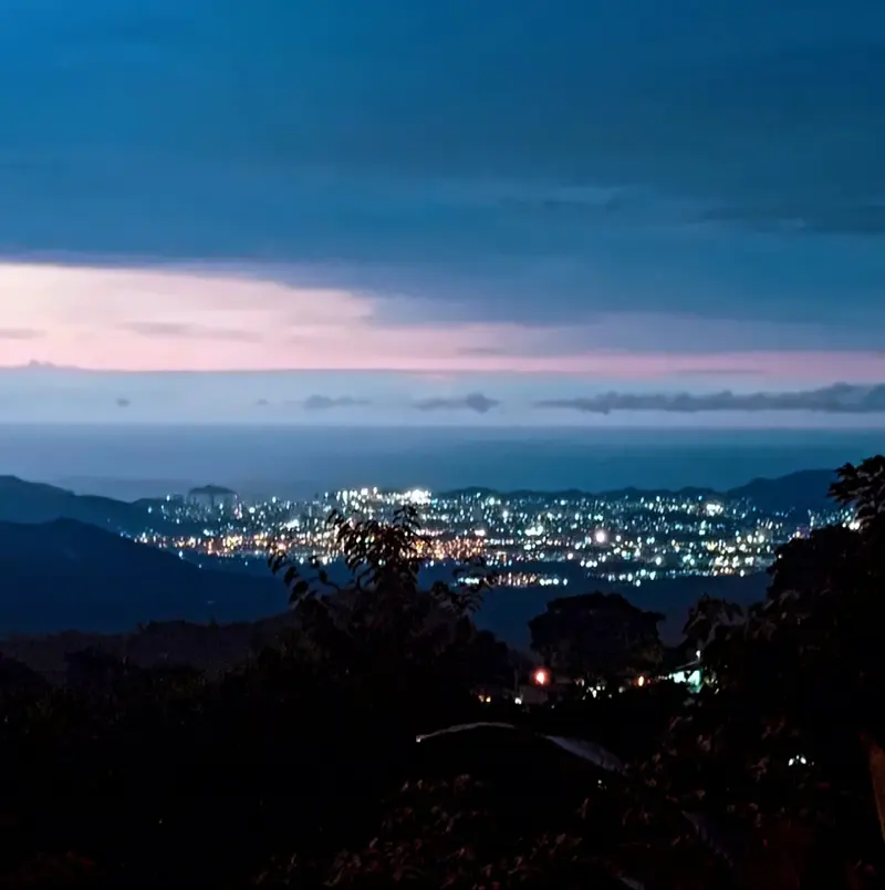 Dusk view from the mountains down to the lights of Santa Marta and the Caribbean Sea